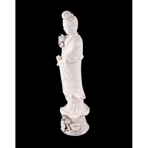 618 - A Chines blanc de chine figure depicting Guanyin standing on a lily pad, 47cms high.