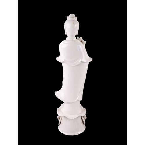 618 - A Chines blanc de chine figure depicting Guanyin standing on a lily pad, 47cms high.