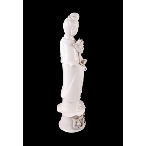 618 - A Chines blanc de chine figure depicting Guanyin standing on a lily pad, 47cms high.