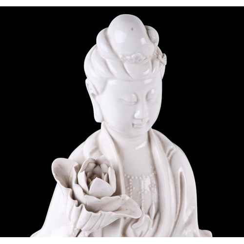 618 - A Chines blanc de chine figure depicting Guanyin standing on a lily pad, 47cms high.