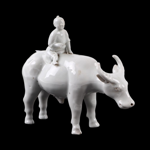 620 - A Chinese blanc de chine group depicting a young boy riding an oxen, 16cms high.