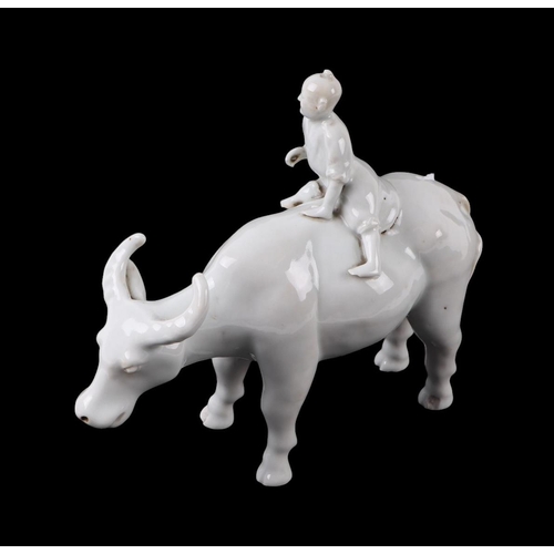 620 - A Chinese blanc de chine group depicting a young boy riding an oxen, 16cms high.