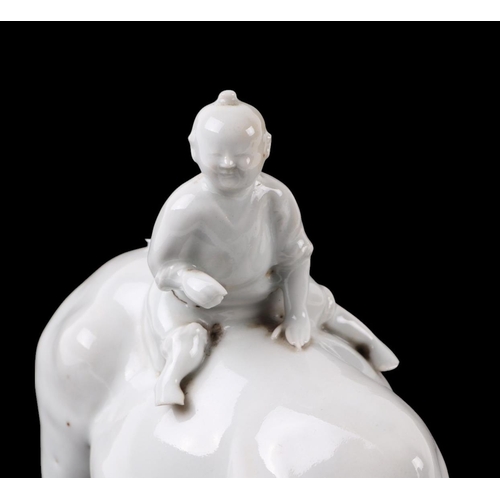 620 - A Chinese blanc de chine group depicting a young boy riding an oxen, 16cms high.