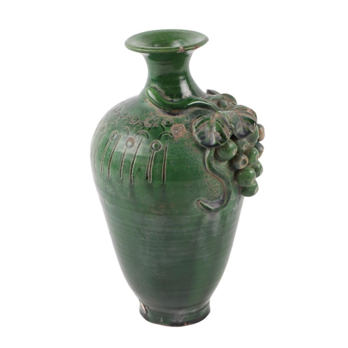 622 - A Chinese green glazed pottery vase decorated with grapes and vine, 17cms high.