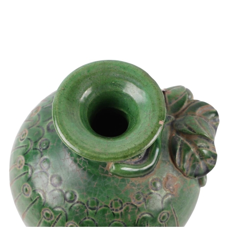 622 - A Chinese green glazed pottery vase decorated with grapes and vine, 17cms high.