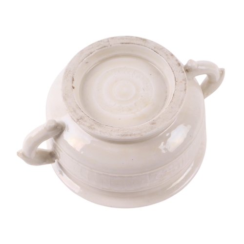 623 - A Chinese blanc de chine two-handled censer with archaic decoration, 11.5cms diameter.