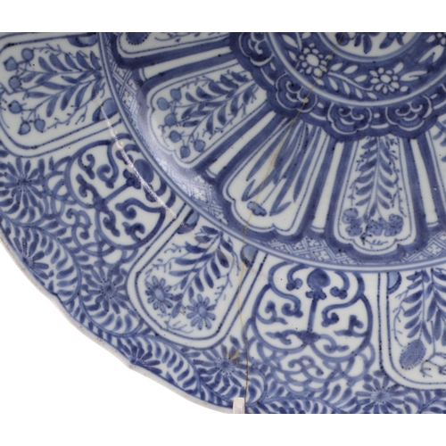 624 - A large Chinese blue & white shallow bowl decorated with flowers, 41cms diameter (restored).