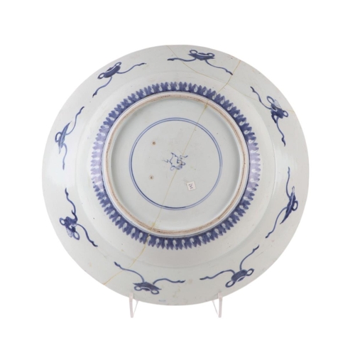 624 - A large Chinese blue & white shallow bowl decorated with flowers, 41cms diameter (restored).