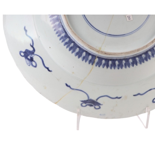 624 - A large Chinese blue & white shallow bowl decorated with flowers, 41cms diameter (restored).