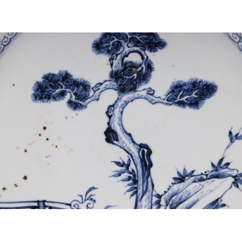 625 - A Chinese blue charger decorated with a fir tree and a fence, 36cms diameter.