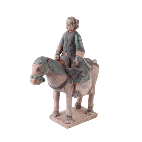 632 - A Chinese Tang Dynasty style polychrome painted terracotta model of a horse and rider, 33cms high.