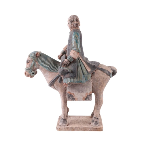 632 - A Chinese Tang Dynasty style polychrome painted terracotta model of a horse and rider, 33cms high.