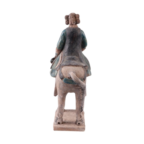 632 - A Chinese Tang Dynasty style polychrome painted terracotta model of a horse and rider, 33cms high.