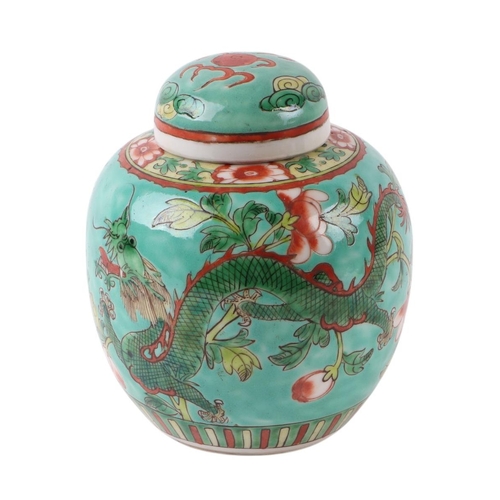 634 - A Chinese famille rose ginger jar and cover decorated with dragons on a green ground, 14cms high.