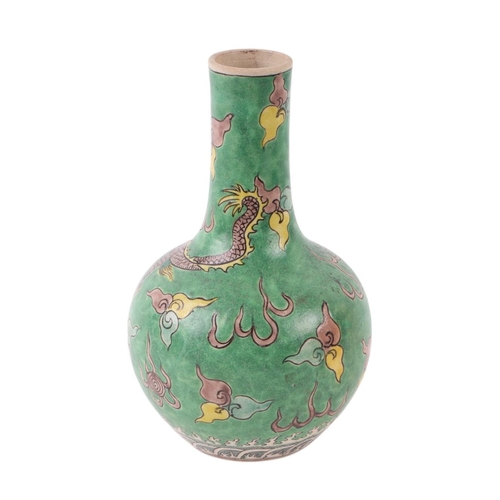 635 - A Chinese bottle vase decorated with a dragon chasing a flaming pearl, on a green ground, 19cms high... 