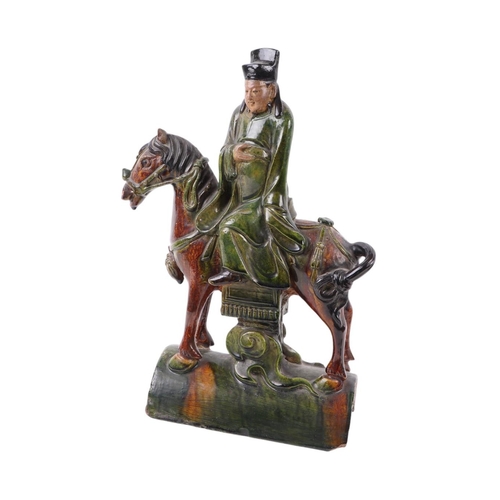 638 - A Chinese terracotta roof tile in the form of a figure on horseback, 41cms high.