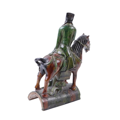 638 - A Chinese terracotta roof tile in the form of a figure on horseback, 41cms high.