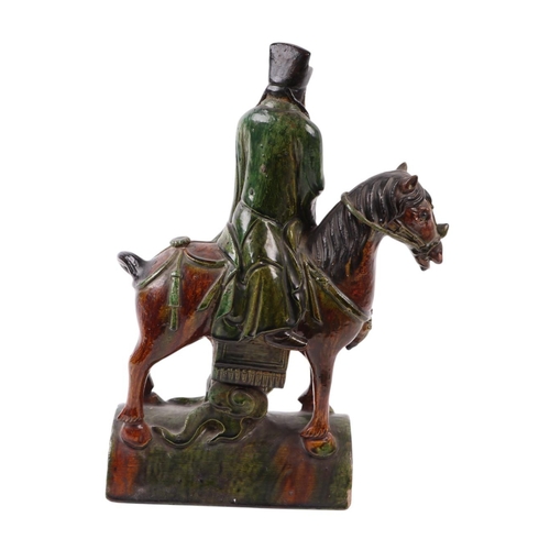 638 - A Chinese terracotta roof tile in the form of a figure on horseback, 41cms high.