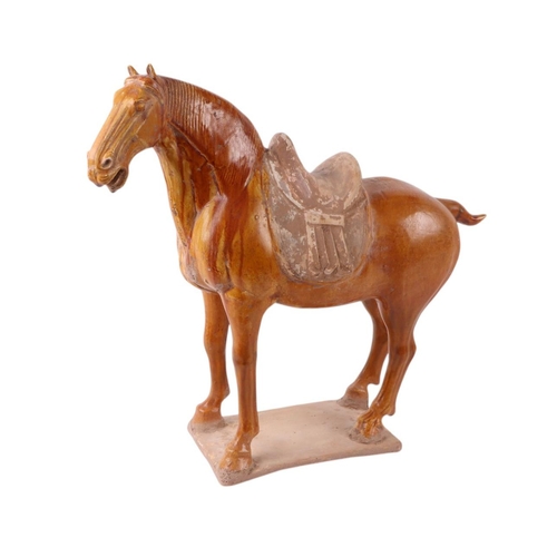 639 - A Chinese amber glazed pottery Tang style horse, 36cms high, with Oxford Authentication certificate.