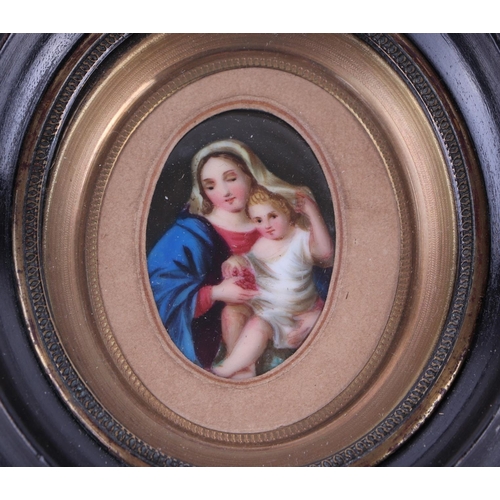 64 - A 19th century porcelain miniature plaque depicting the Madonna and Christ Child in a gilt brass and... 