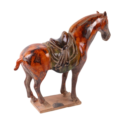 641 - A Chinese glazed Tang style pottery horse, 24cms high.