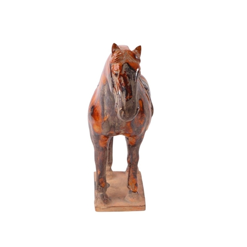 641 - A Chinese glazed Tang style pottery horse, 24cms high.