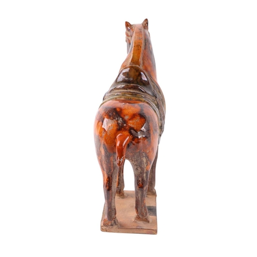 641 - A Chinese glazed Tang style pottery horse, 24cms high.