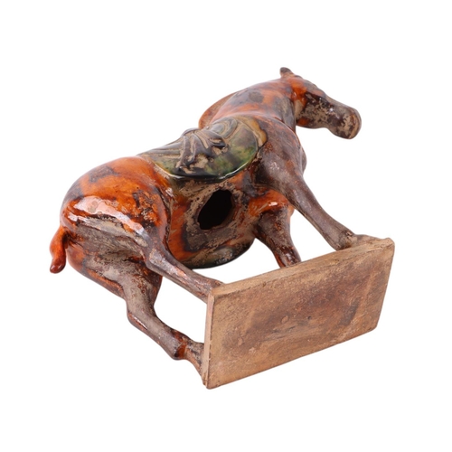 641 - A Chinese glazed Tang style pottery horse, 24cms high.