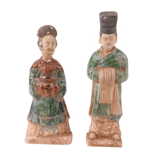 644 - A pair of Chinese glazed funerary figures, possibly Tang Dynasty, the largest 25cms high (2).