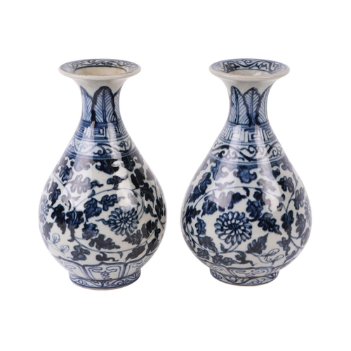 646 - A pair of Chinese blue & white vases decorated with flowers and foliate scrolls, 15cms high.