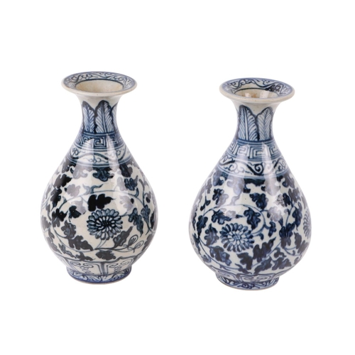 646 - A pair of Chinese blue & white vases decorated with flowers and foliate scrolls, 15cms high.