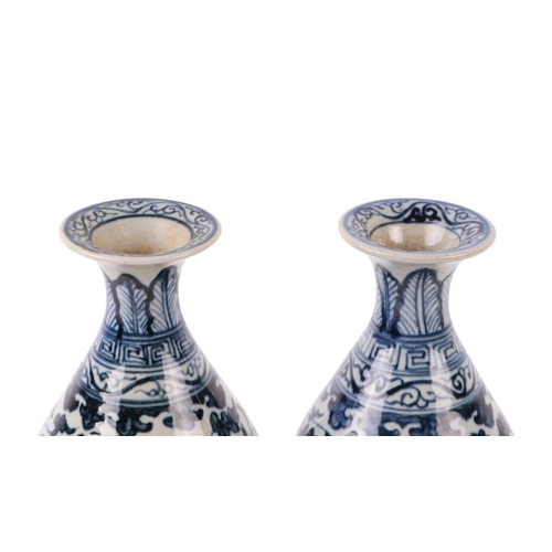 646 - A pair of Chinese blue & white vases decorated with flowers and foliate scrolls, 15cms high.