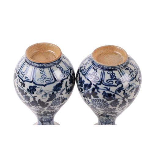 646 - A pair of Chinese blue & white vases decorated with flowers and foliate scrolls, 15cms high.