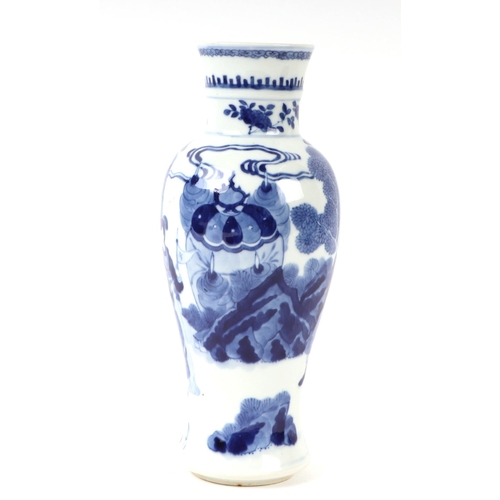 648 - A Chinese blue & white baluster vase decorated with figures in a landscape, 25cms high.