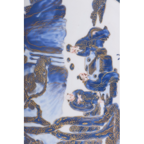 649 - A Chinese blue & white plate decorated with figures playing a board game under a fir tree, with gilt... 