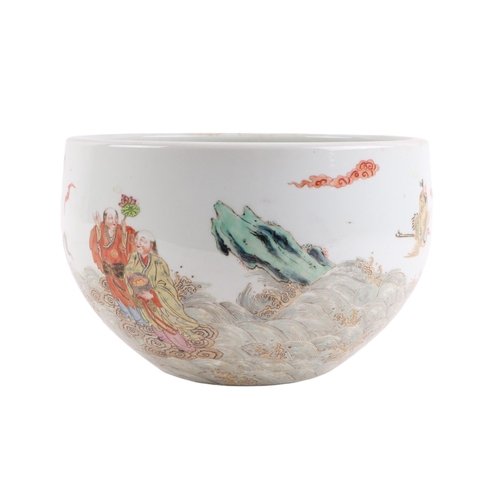 666 - A Chinese famille rose fish bowl decorated with Immortals and bats in a stylised sea, 26cms diameter... 