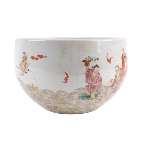 666 - A Chinese famille rose fish bowl decorated with Immortals and bats in a stylised sea, 26cms diameter... 