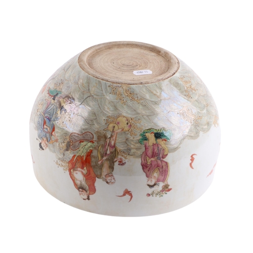 666 - A Chinese famille rose fish bowl decorated with Immortals and bats in a stylised sea, 26cms diameter... 