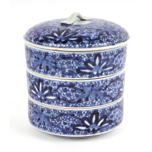 669 - A Chinese blue & white three-section stacking box and cover of cylindrical form decorated with styli... 