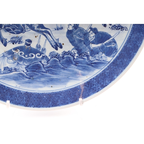 670 - A Chinese blue & white charger decorated with warriors on horseback, 41cms diameter.