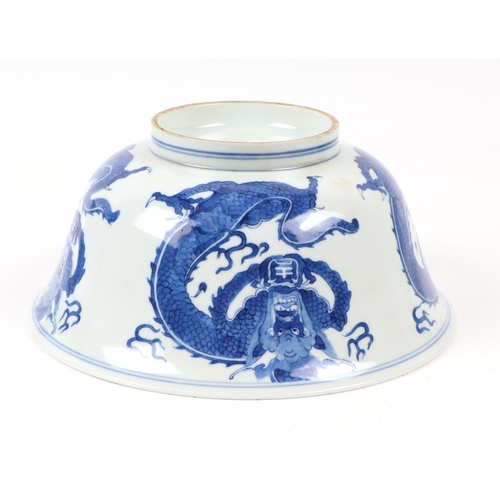 673 - A Chinese blue & white bowl decorated with dragons, 20cms diameter; together with a Chinese blue & w... 