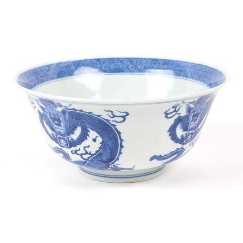 673 - A Chinese blue & white bowl decorated with dragons, 20cms diameter; together with a Chinese blue & w... 