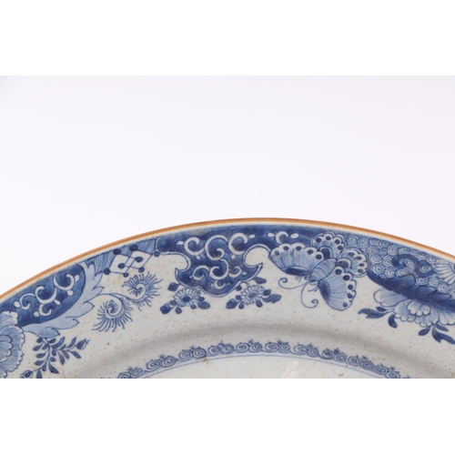 674 - A large Chinese blue & white charger decorated with figures in a garden, 54cms diameter.