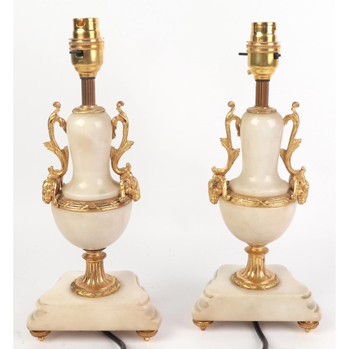 680 - A pair of gilt ormolu mounted marble table lamps, each 24cms high excluding fittings.