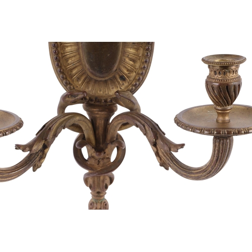 681 - A pair of 19th century French gilded bronze candlesticks, 23.5cms high; together with a Regency styl... 