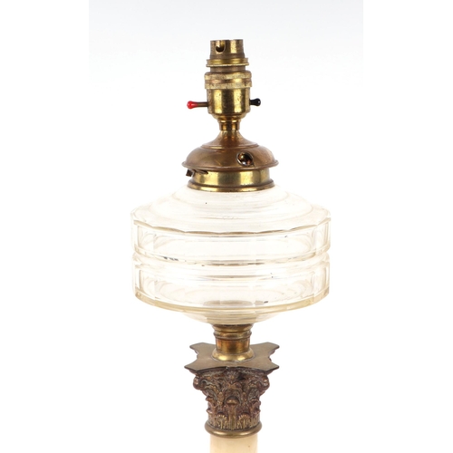 689 - A late 19th century oil lamp on a brass and marble Corinthian column with clear glass reservoir, con... 