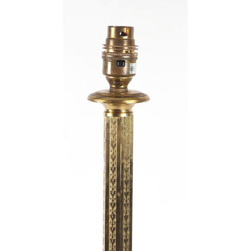 693 - A brass standard lamp with hexagonal column on a circular stepped base, 130cms high.