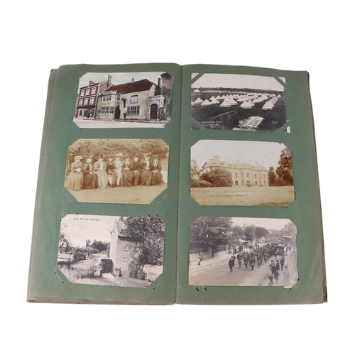 722 - An Edwardian postcard album containing topographical and comical cards; together with some loose pos... 