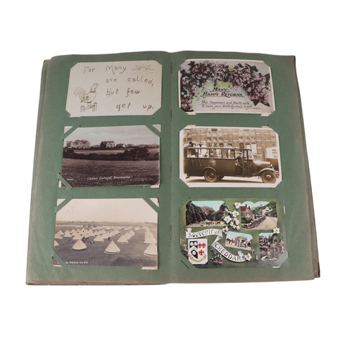 722 - An Edwardian postcard album containing topographical and comical cards; together with some loose pos... 