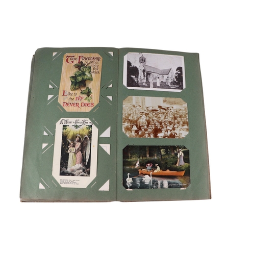 722 - An Edwardian postcard album containing topographical and comical cards; together with some loose pos... 